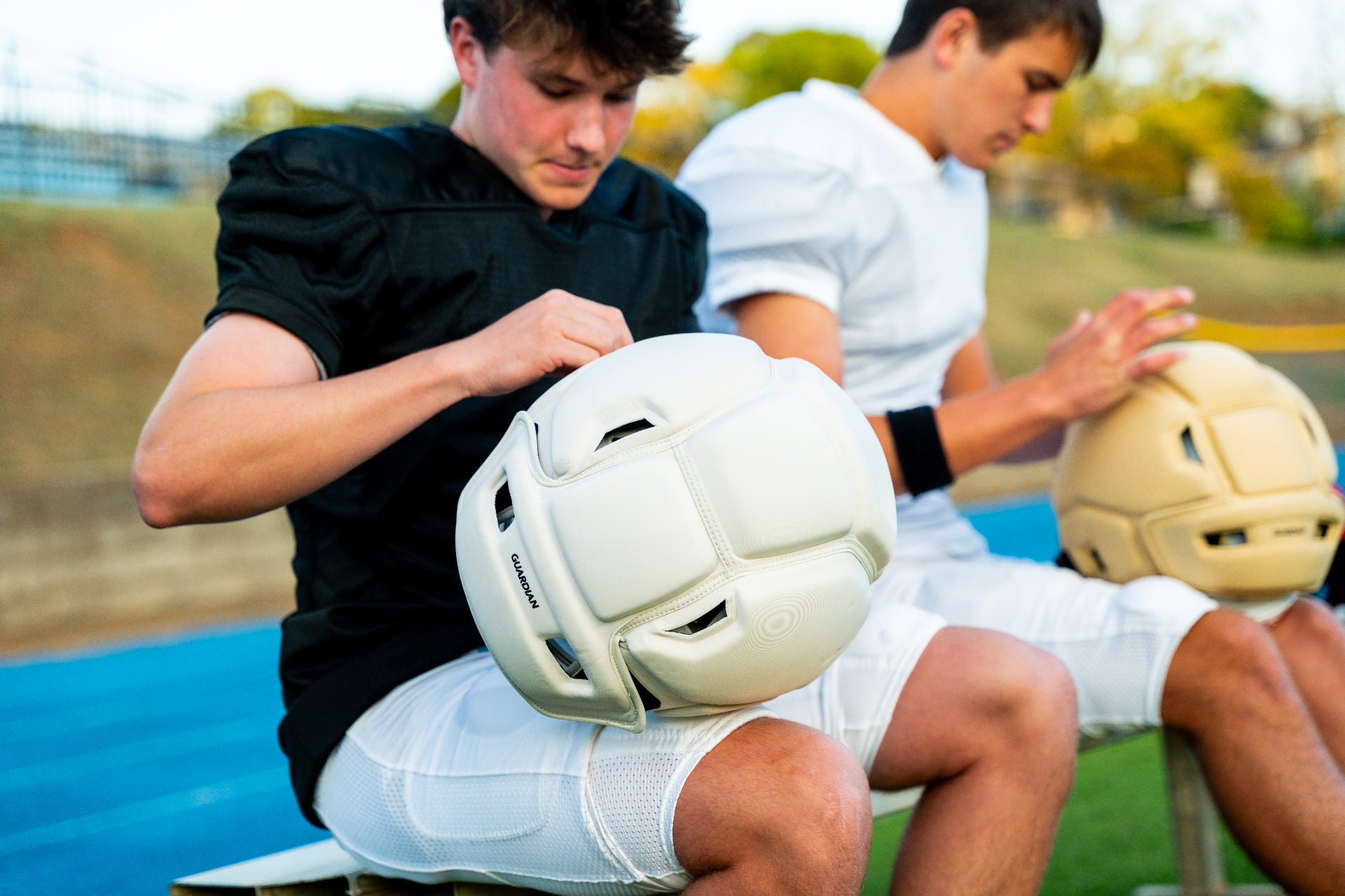 Football team in formation wearing Guardian Caps during practice